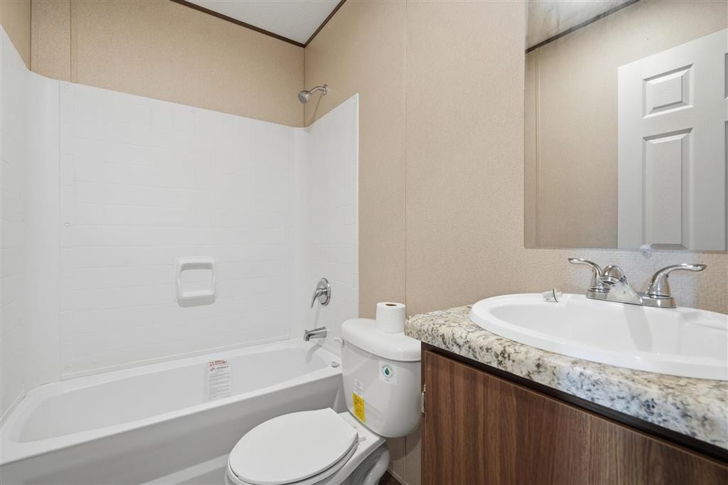 Bathroom with tub and shower combination, vanity, and toilet
