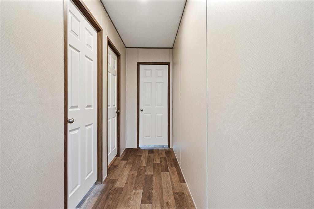 Interior hallway with white paneled doors to bedrooms and baths