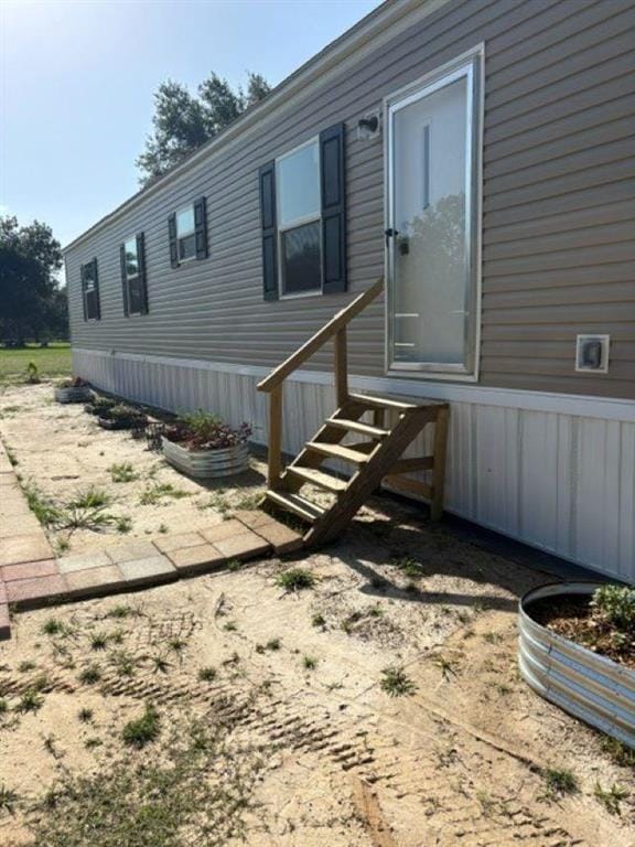 Front entry with wooden steps leading to the door of the new manufactured home