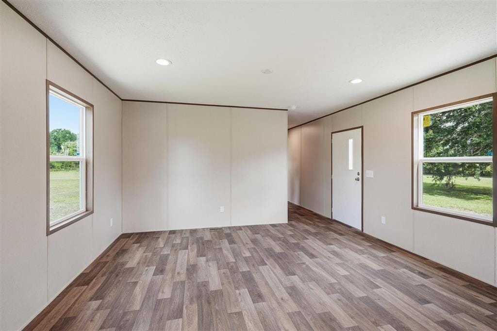 Living room with entry door and windows overlooking the property